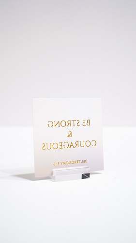 business card white paper with be strong and courageous printed text paper